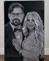 Decorative wall art of a couple made from rhinestones on a black background