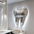 A dazzling custom commission for a dentist's office, featuring a stunning wall hanging crafted from shimmering mirror tiles in the shape of a tooth.