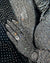 Close-up of a black fabric with silver rhinestone embellishments